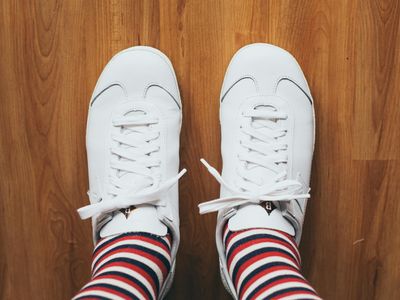 Athletic shoes on a wooden floor close up.