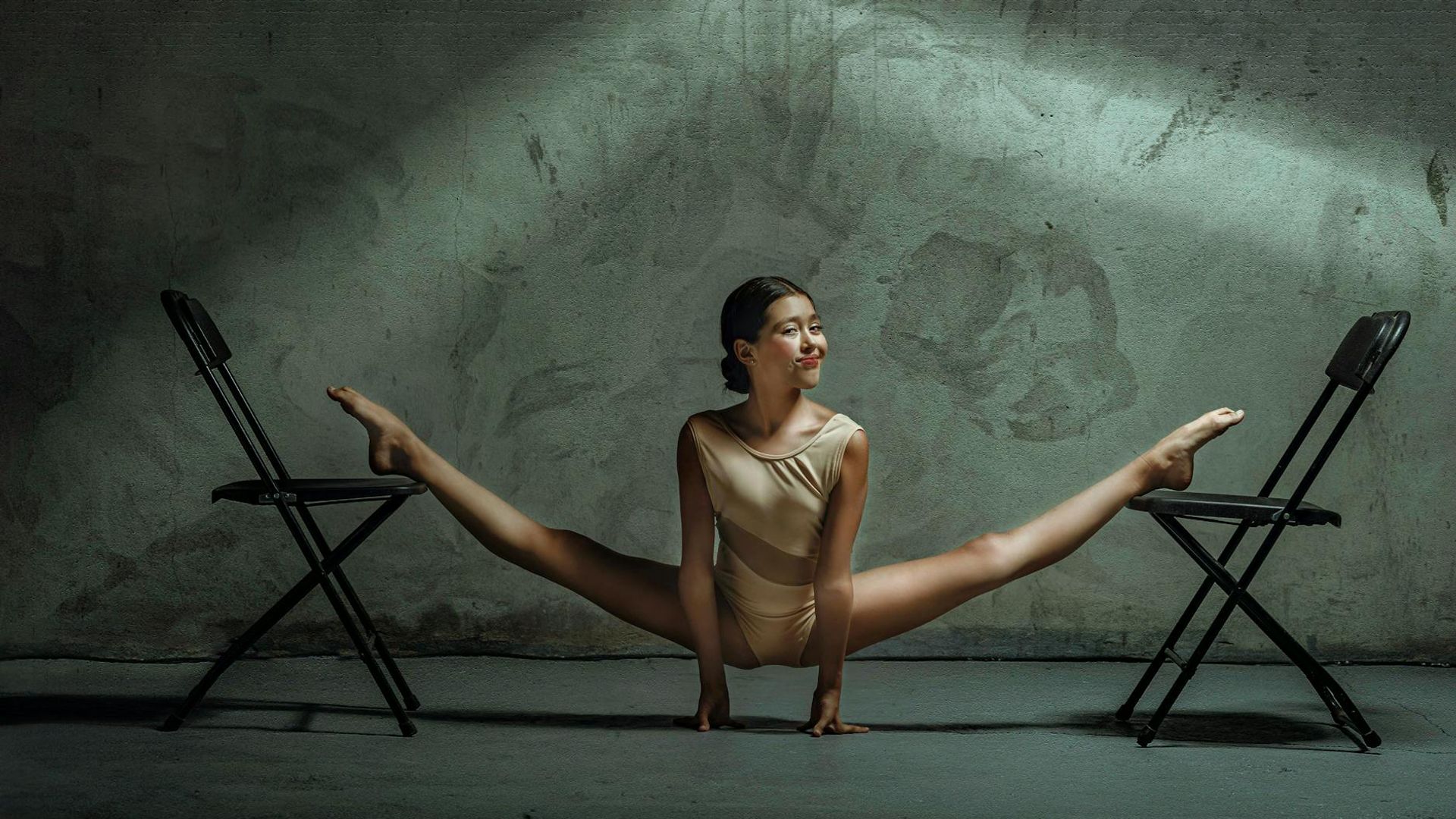 Person doing rhythmic exercises in a bright spacious studio.